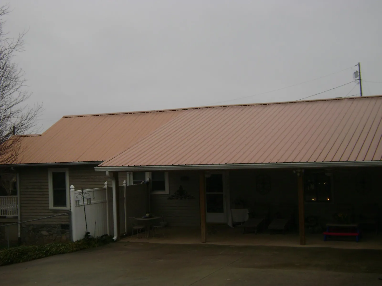 Copper toned metal roof over a wide covered patio in Vienna
